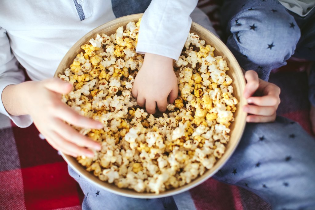 Two kids sharing a bowl of Popcorn