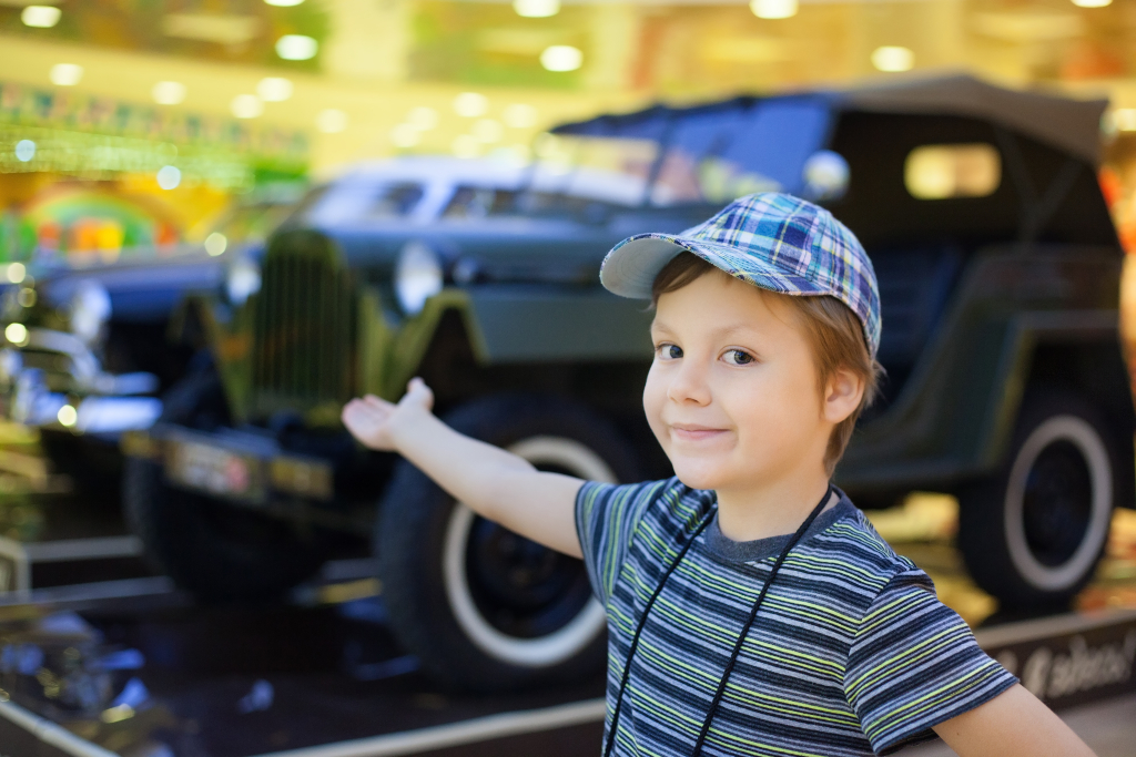 Boy showing exhibits at a car exhibition