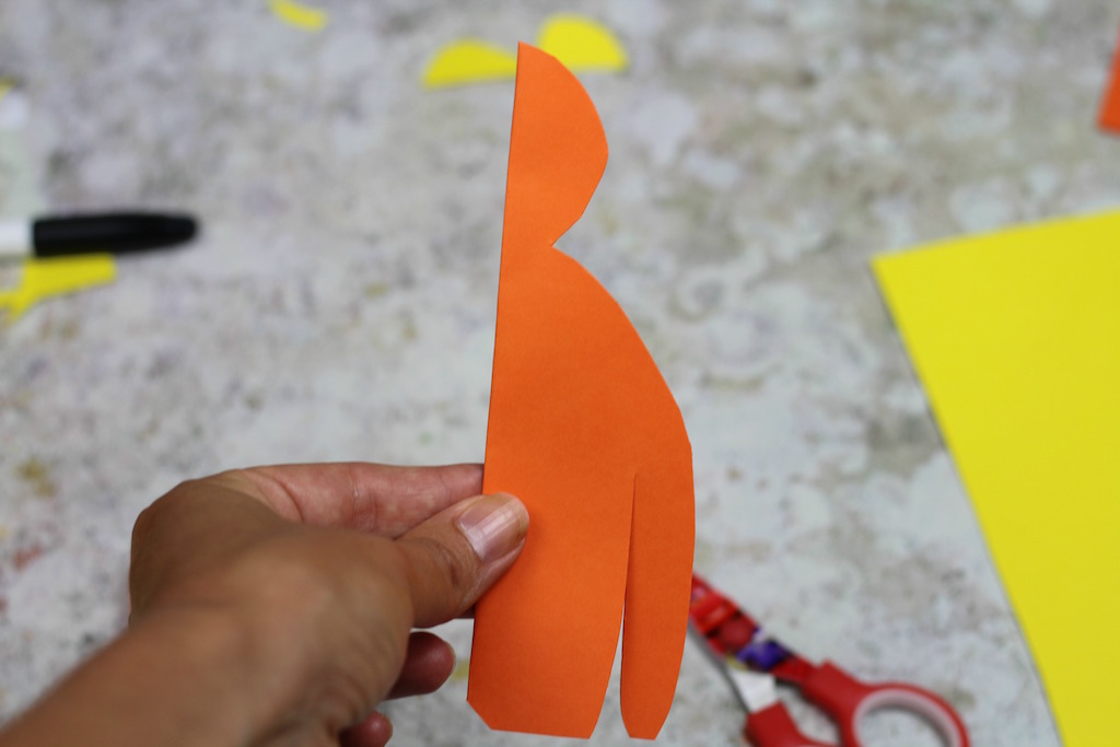 Orange card in the shape of an orangutan, folded in half