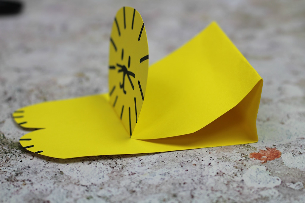 A crouching lion craft made using yellow card