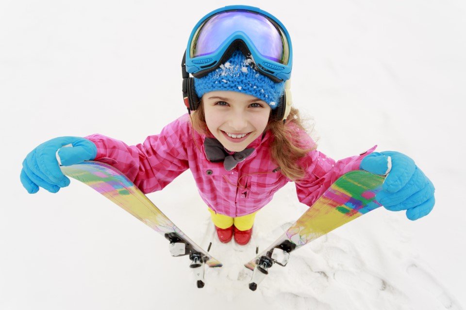 Girl holding ski