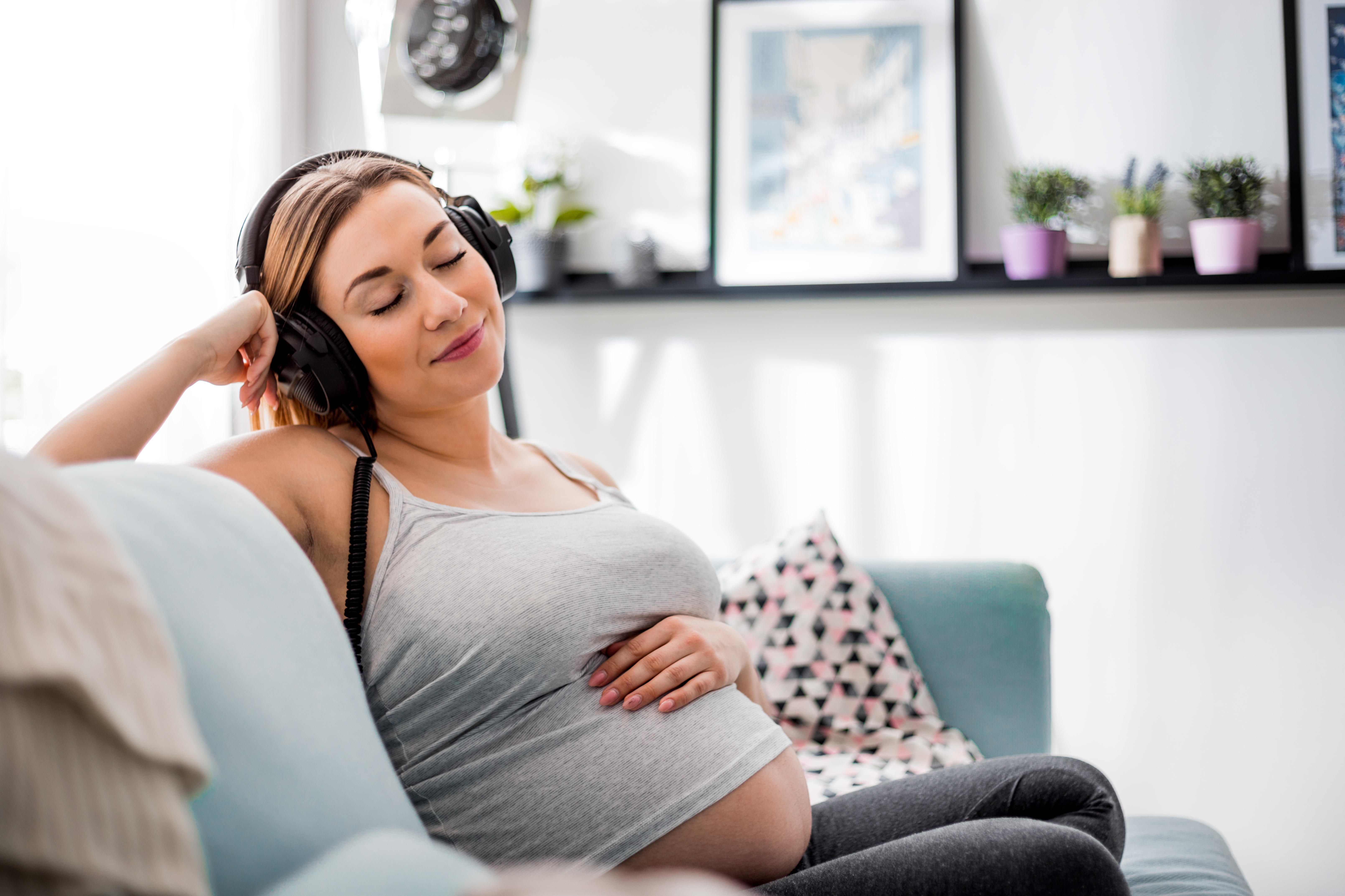 A pregnant Mum with headphones on