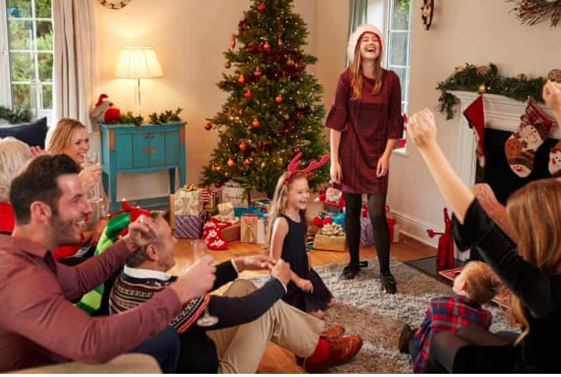A family laughing in their living room at Christmas
