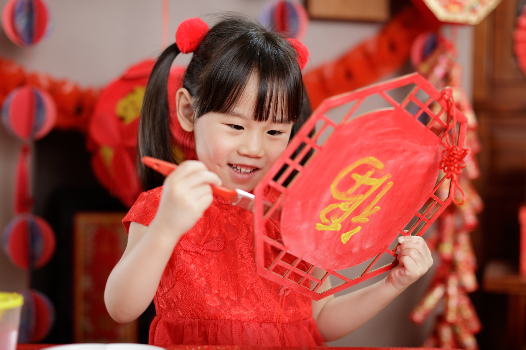 Chinese girl making a new year lantern